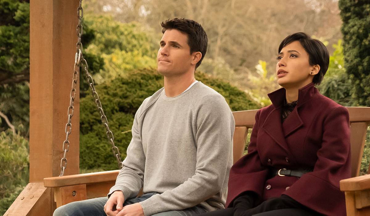 Nathan and Nora look out while sitting together in Lakeview