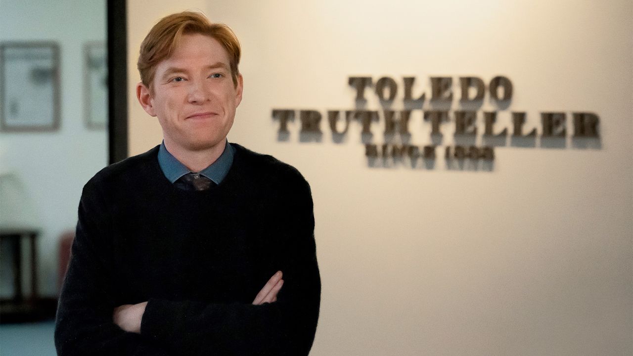Ned in front of the Toledo Truth Teller sign in The Paper